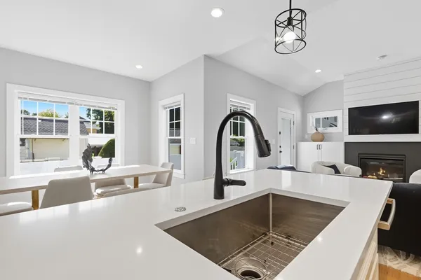 a kitchen with a refrigerator a sink and a stove top oven