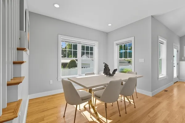 a view of a dining room with furniture and wooden floor