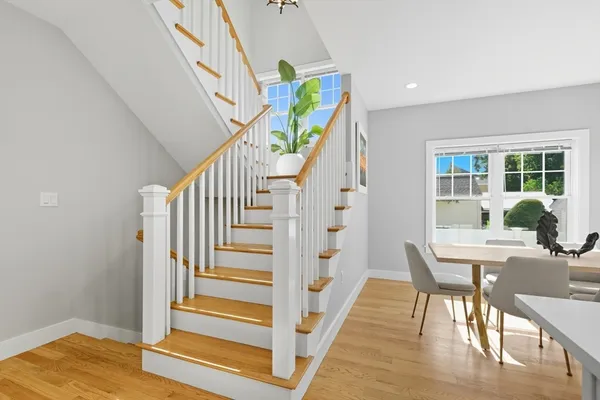 a view of entryway and hall with wooden floor