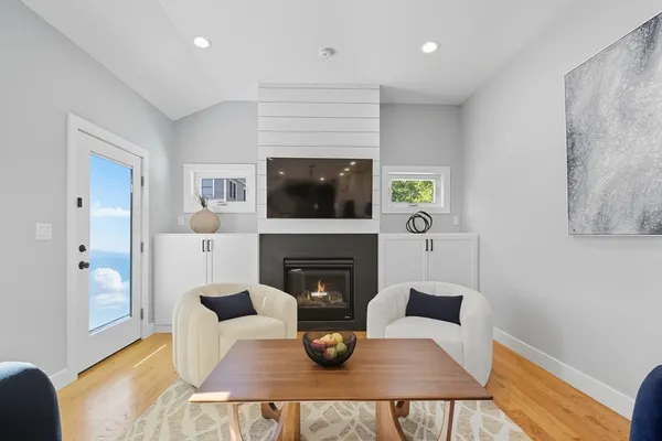 a living room with furniture a fireplace and a flat screen tv