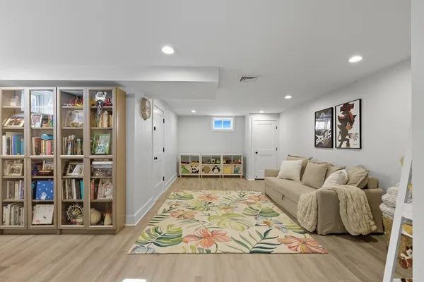 a living room with furniture and a book shelf