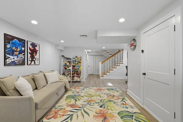 a living room with furniture and wooden floor
