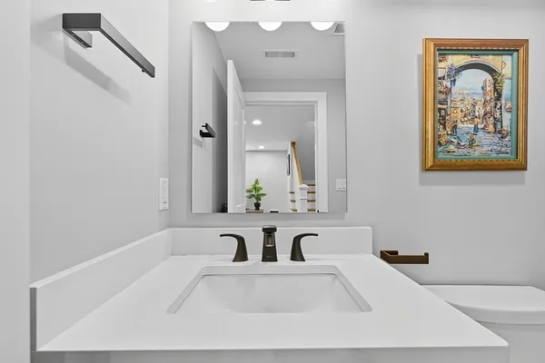 a view of a bathroom with a tub sink and mirror