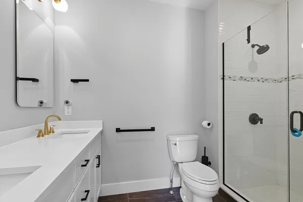 a bathroom with a sink toilet and shower