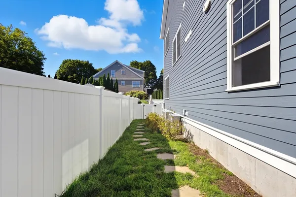 a view of a house with a yard and sitting area