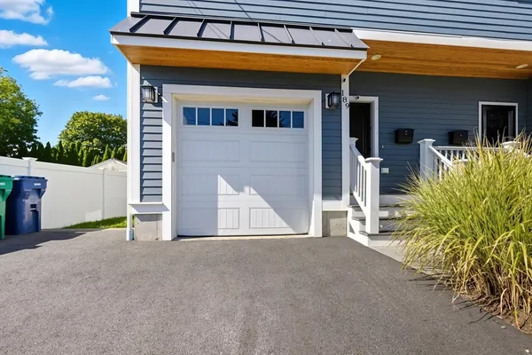 a view of a house with a garage and a chair