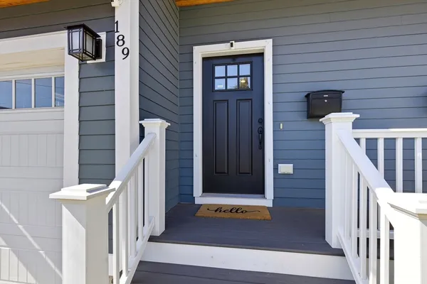 a view of front door of house with stairs