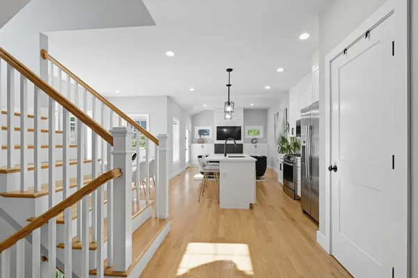 a view of a kitchen with furniture and wooden floor