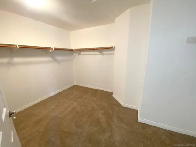 a view of a room with shelf on the wall