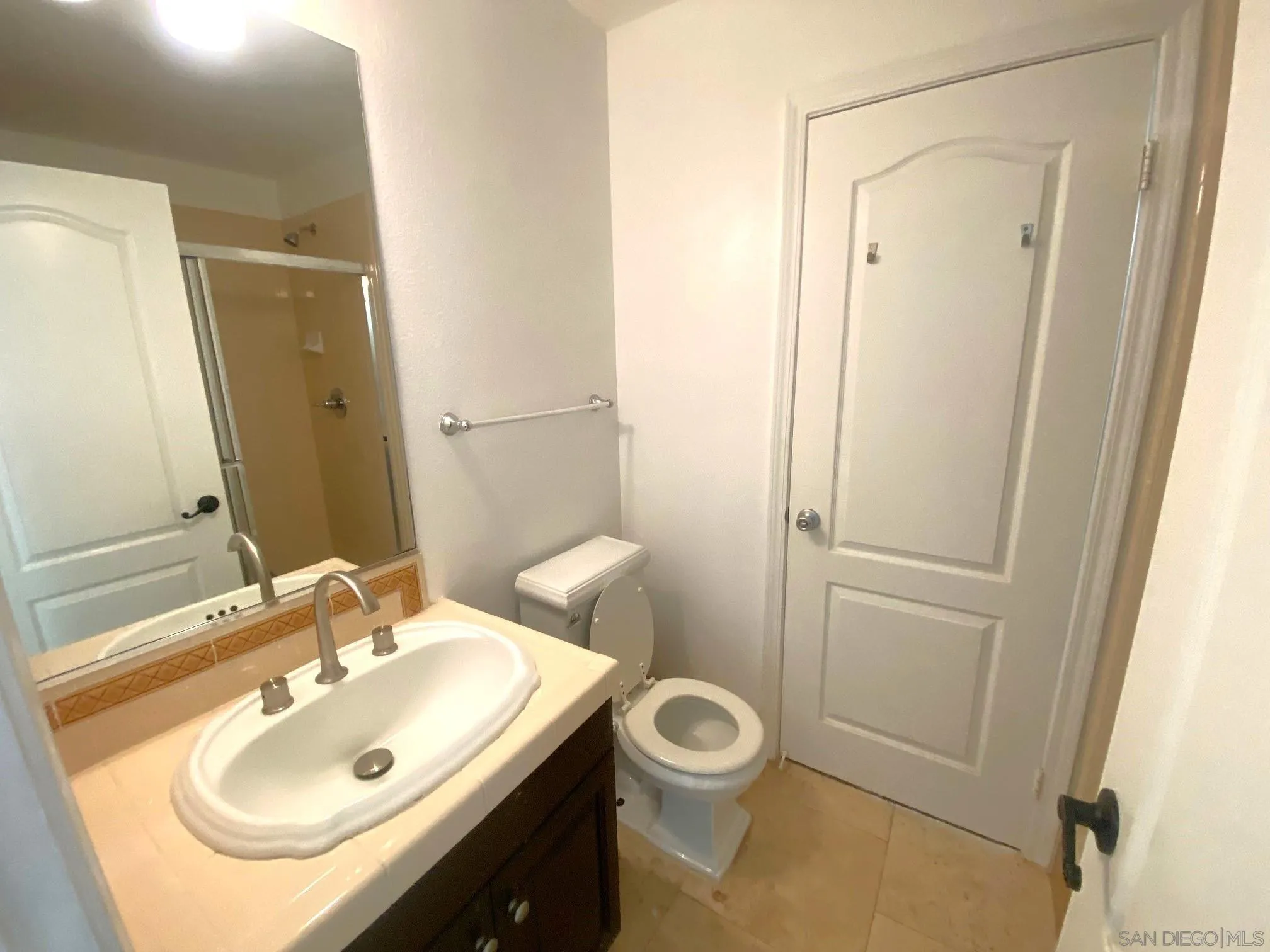 5517 Rabbit Ridge Road San Diego, CA 92130 - Photo 9 of 20 a bathroom with a sink toilet and shower
