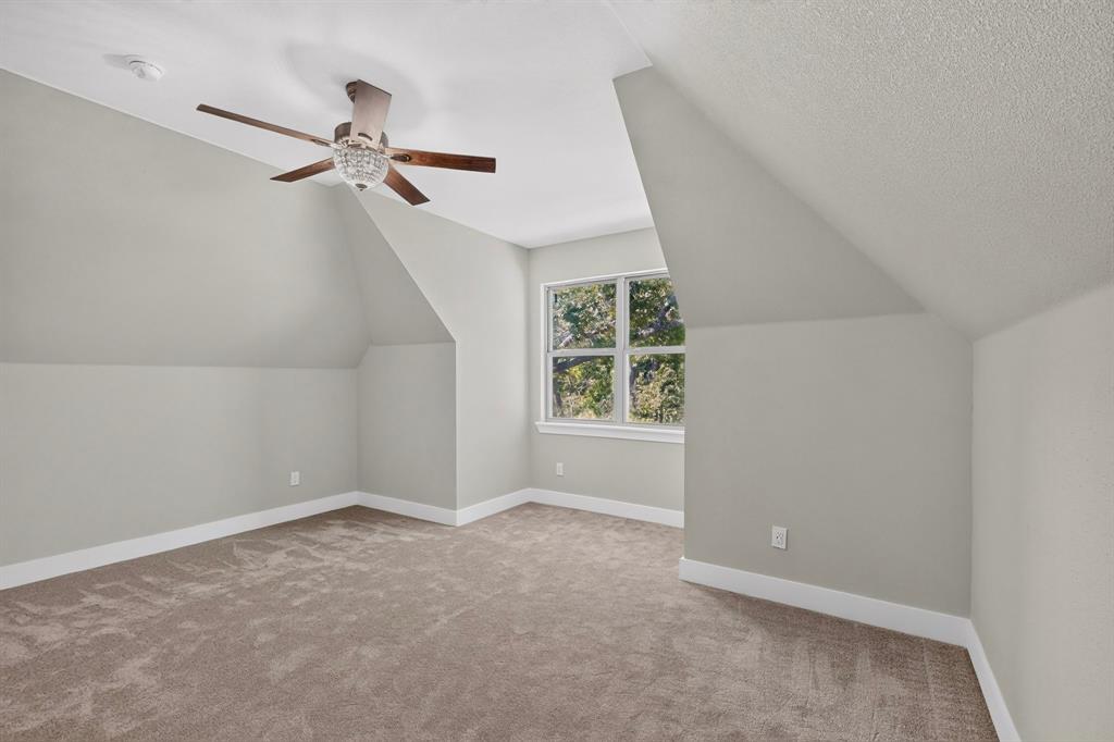 108 Winding Way Azle, TX 76020 - Photo 26 of 38 Can be used as a 4th bedroom or media room with vaulted ceiling with a decorative ceiling fan, window with multiple panes, sloped ceiling detail, and carpet flooring