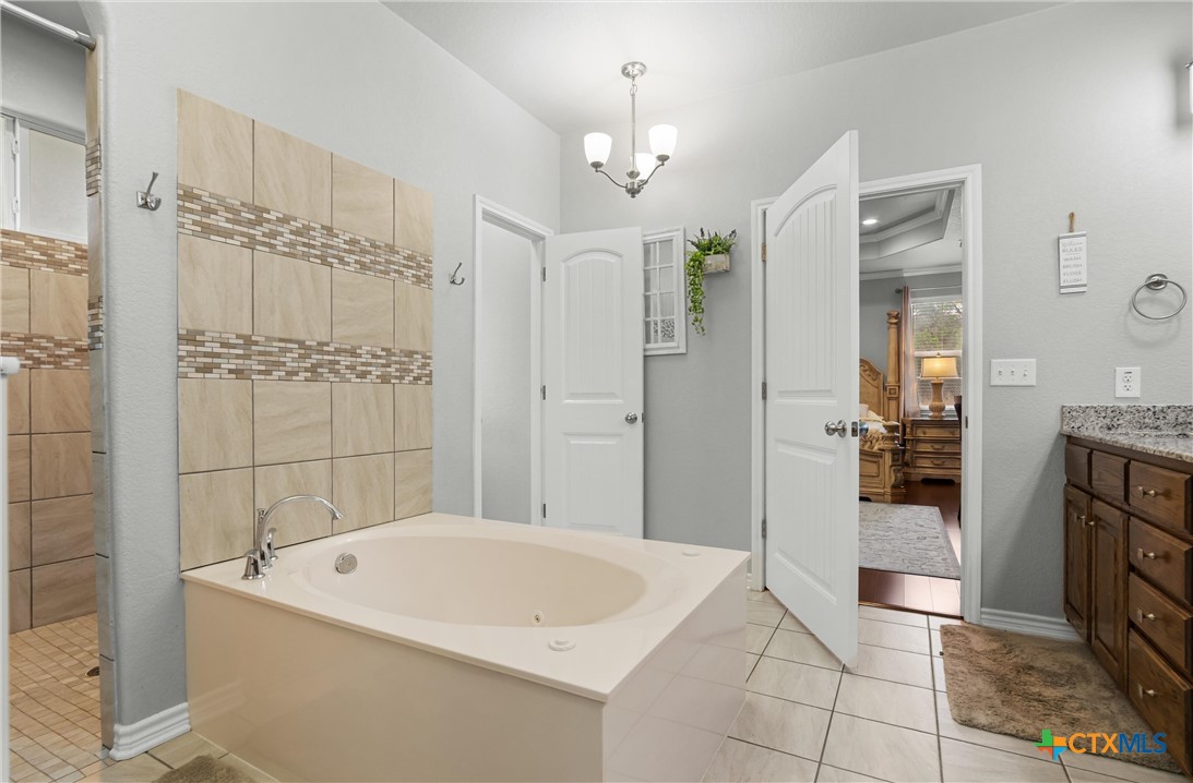16017 Toby Court Temple, TX 76502 - Photo 17 of 33 a bathroom with a bathtub and a shower