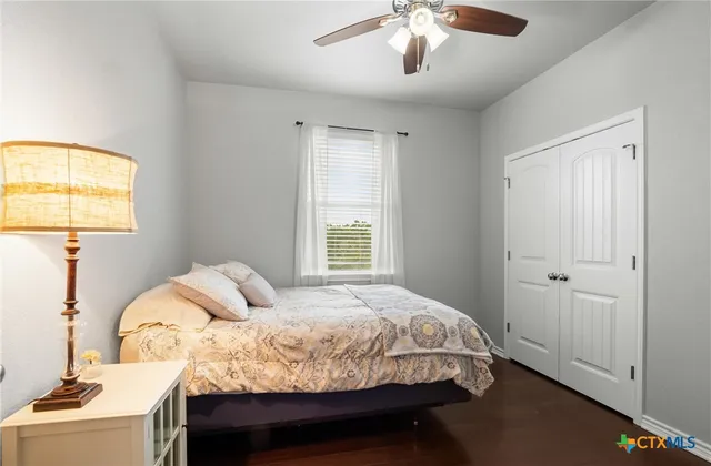 a bed sitting in a bedroom next to a window