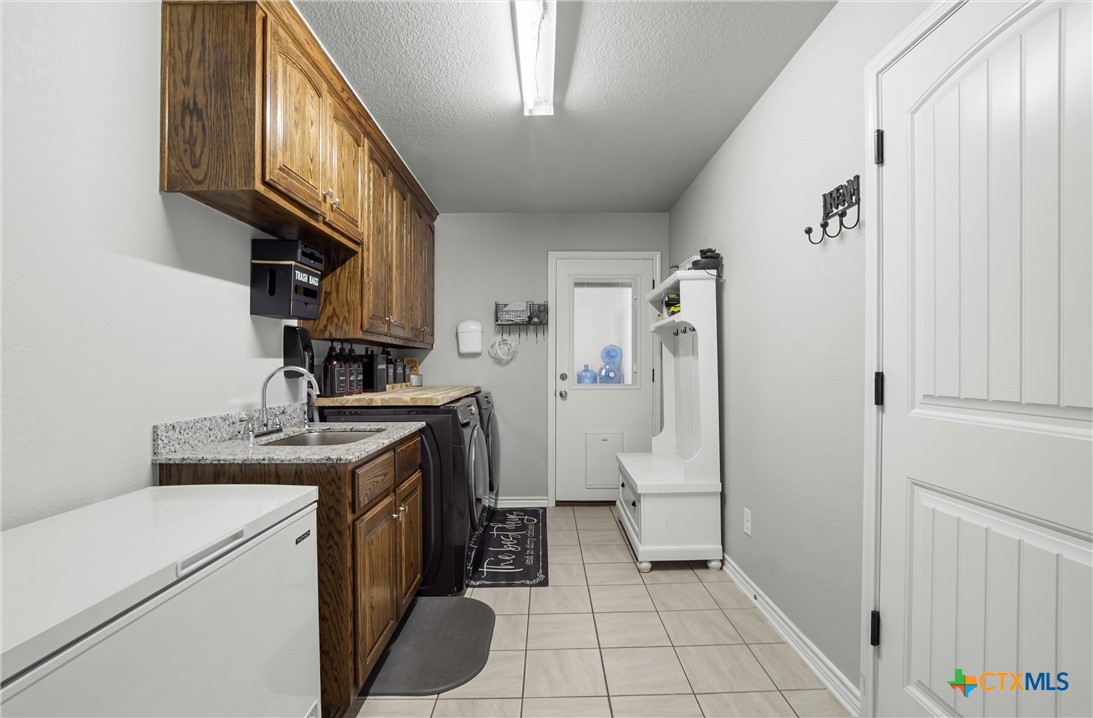 16017 Toby Court Temple, TX 76502 - Photo 22 of 33 a view of a kitchen with fridge and wooden floor