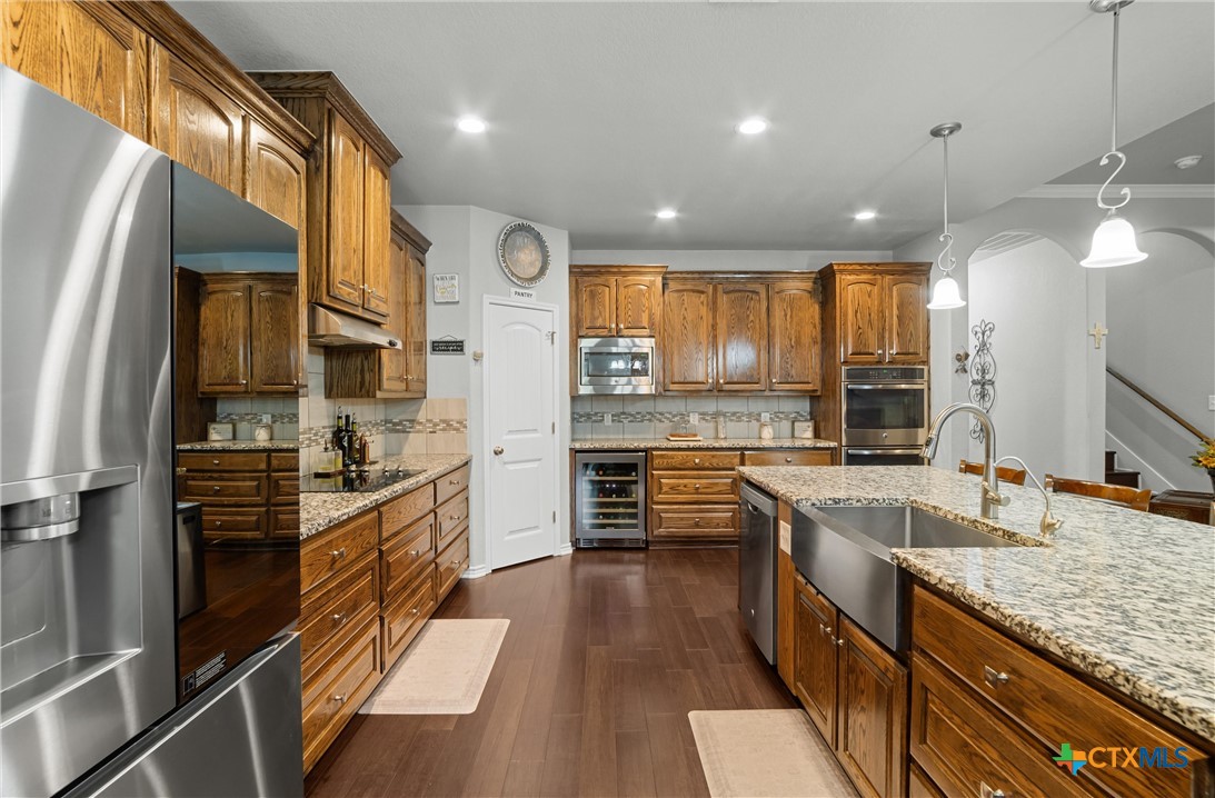 16017 Toby Court Temple, TX 76502 - Photo 10 of 33 a kitchen with stainless steel appliances granite countertop sink stove refrigerator and cabinets