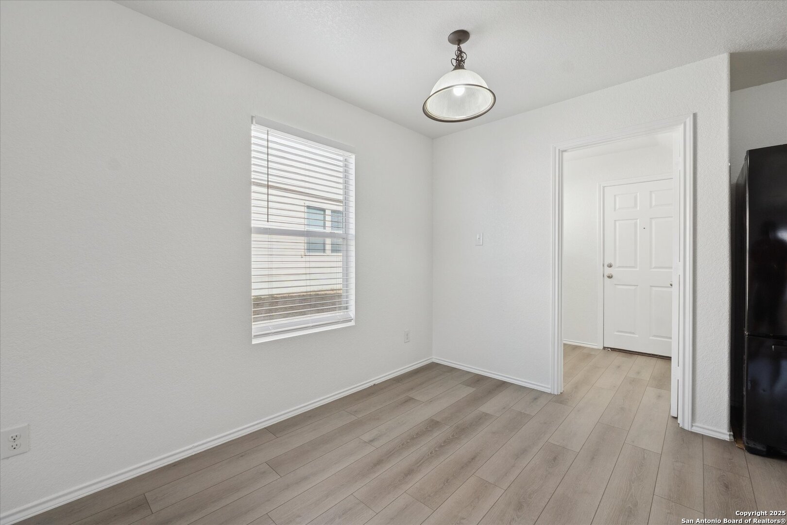 9219 Hanover Cove Converse, TX 78109 - Photo 11 of 46 an empty room with wooden floor and windows