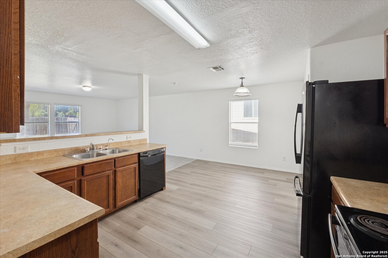 9219 Hanover Cove Converse, TX 78109 - Photo 17 of 46 a kitchen with stainless steel appliances granite countertop a sink stove and refrigerator