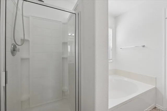 a bathroom with a glass shower door