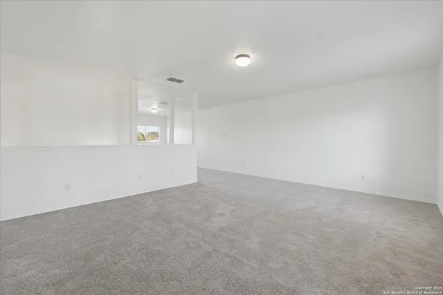 an empty room with windows and entrance