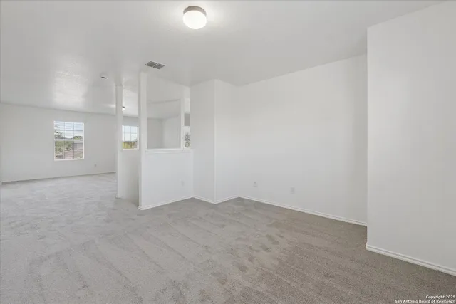 an empty room with a empty space and windows