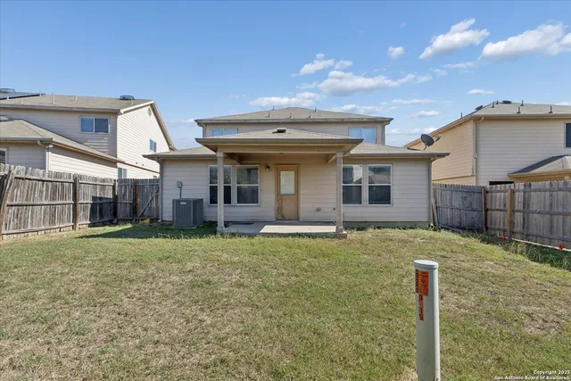 a backyard of a house with table and chairs