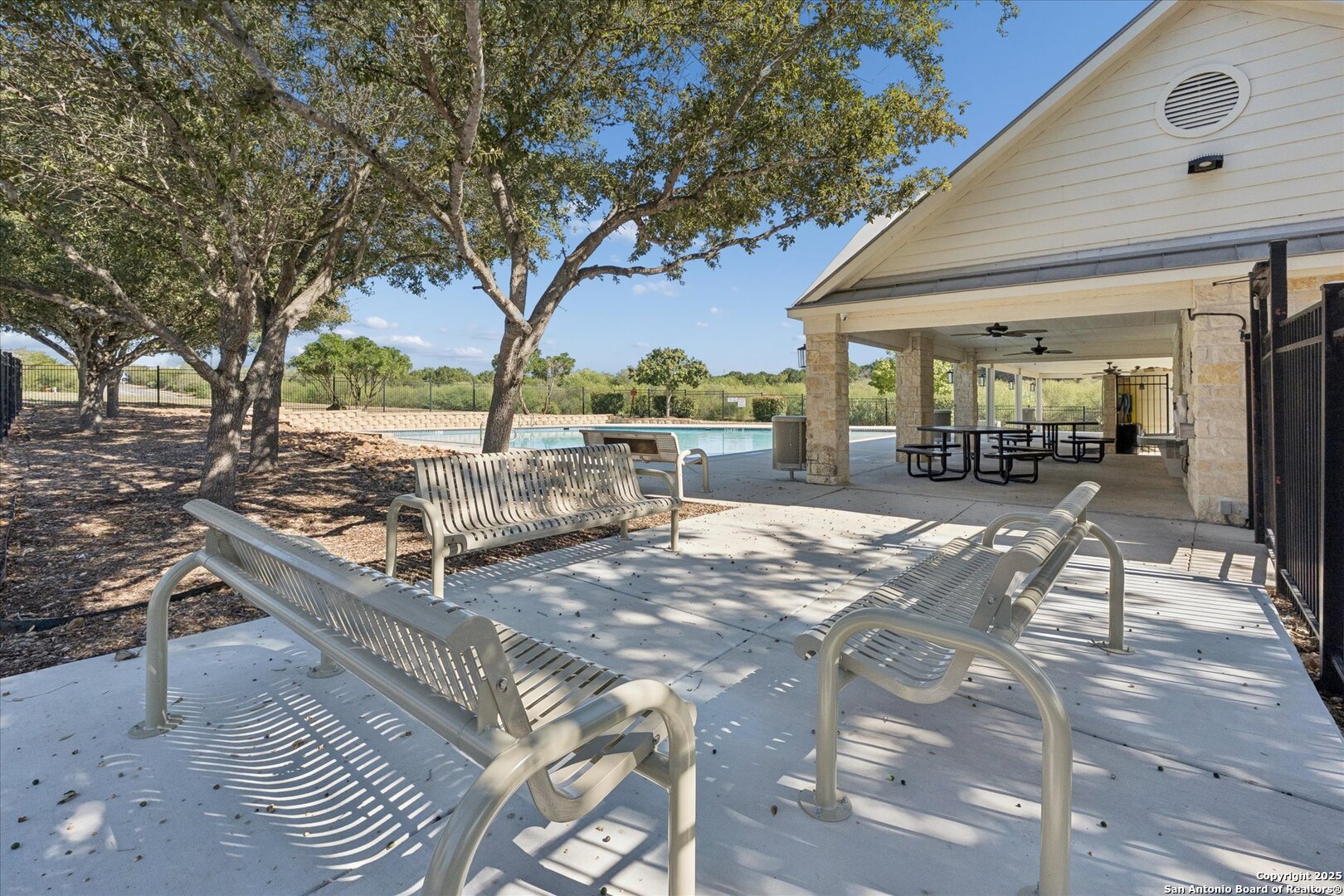 9219 Hanover Cove Converse, TX 78109 - Photo 44 of 46 a view of a backyard with table and chairs potted plants and large tree