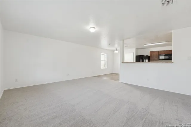 a view of a kitchen with a sink and a refrigerator