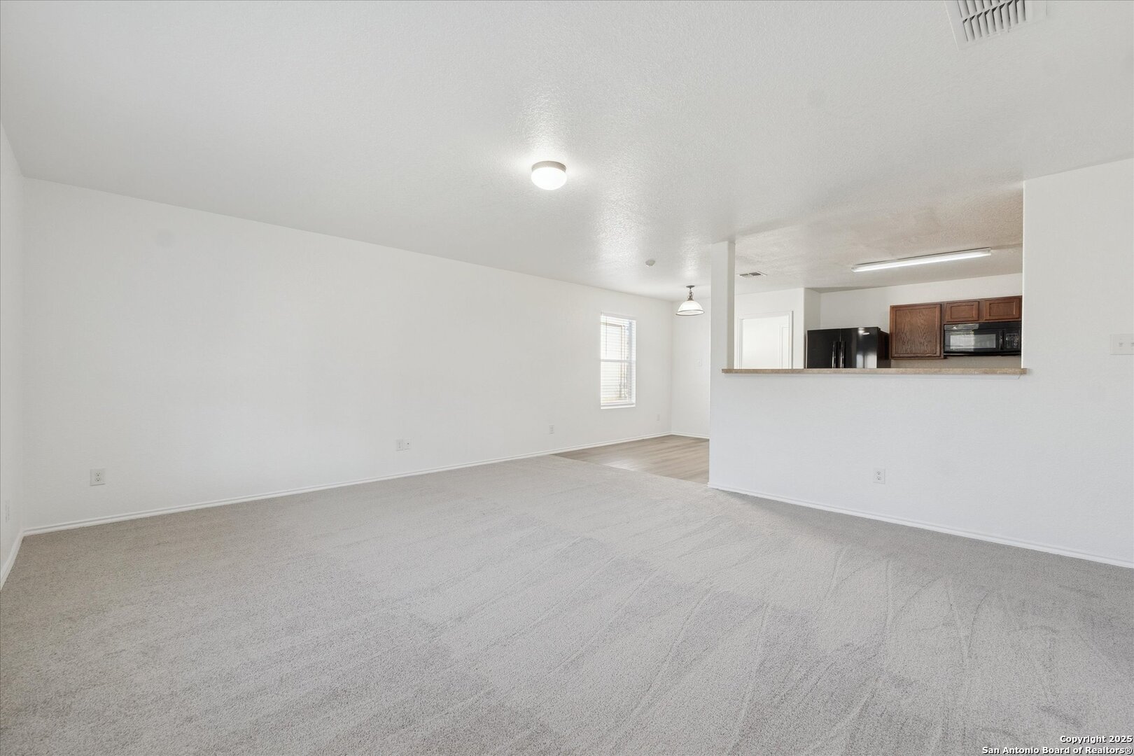 9219 Hanover Cove Converse, TX 78109 - Photo 9 of 46 a view of a kitchen with a sink and a refrigerator