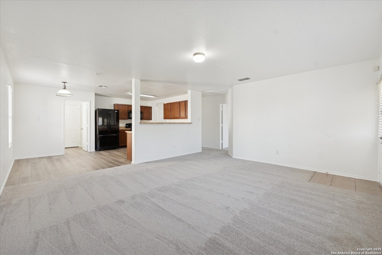 9219 Hanover Cove Converse, TX 78109 - Photo 10 of 46 a view of a big room with wooden floor and windows