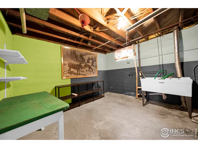 a room with pool table a flat screen tv and couches