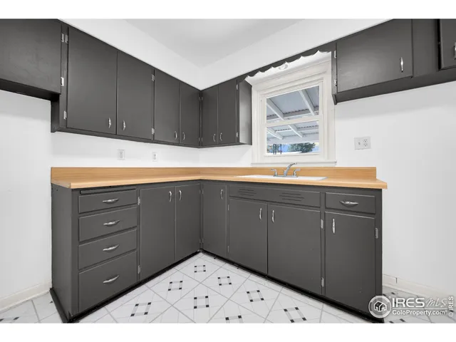 a kitchen with a sink and cabinets