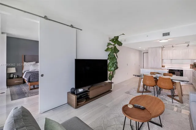 a view of a terrace with furniture and a floor to ceiling window