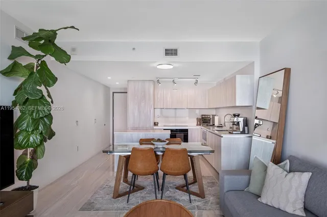 a bedroom with a bed and a flat tv screen on dresser