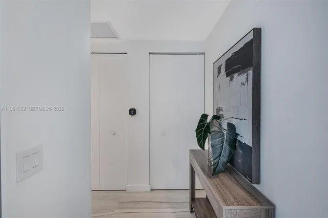 a bedroom with a bed and painting on the wall