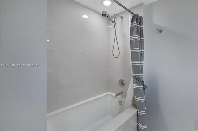 a spacious bedroom with a bed and a large window