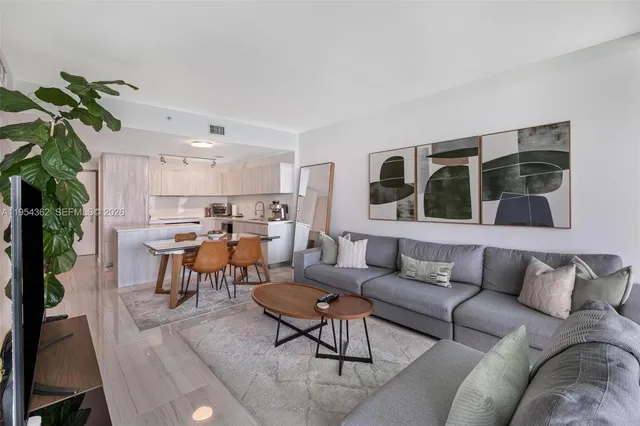 a bedroom with a large bed and a large window with balcony view