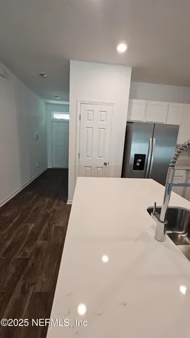 a large white bed in a white room