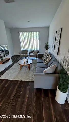 a living room with furniture and a potted plant