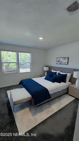 a bedroom with a large bed and a couch