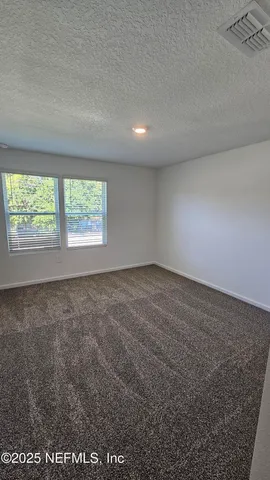 an empty room with a empty space and windows