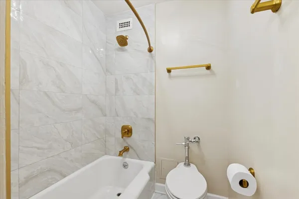 a bathroom with a tub sink and mirror