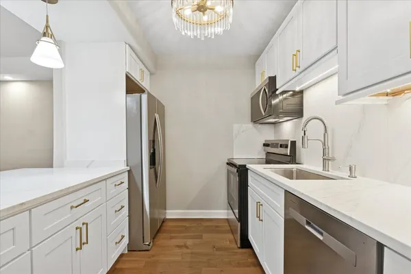 a kitchen with a sink and a refrigerator