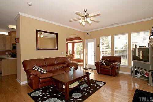8345 Tie Stone Way Raleigh, NC 27613 - Photo 3 of 12 a living room with furniture a flat screen tv and a large window