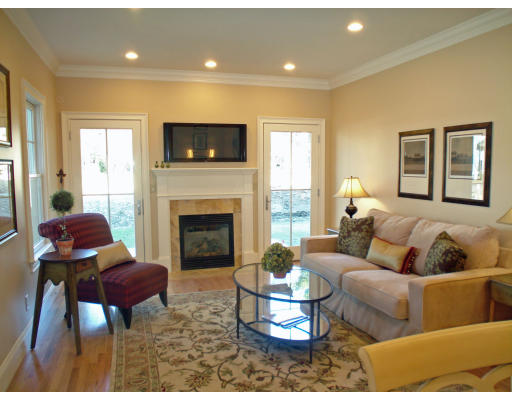 26 Journeys End Lane, Unit 26 Lexington, MA 02421 - Photo 1 of 1 a living room with furniture and a fireplace