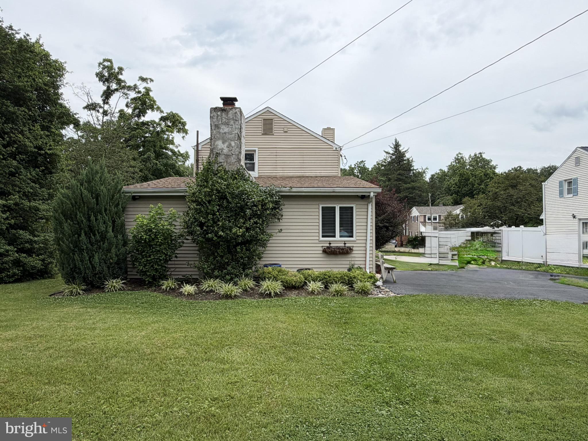 217 Lyster Road Oreland, PA 19075 - Photo 4 of 11 Charming home with lush greenery.