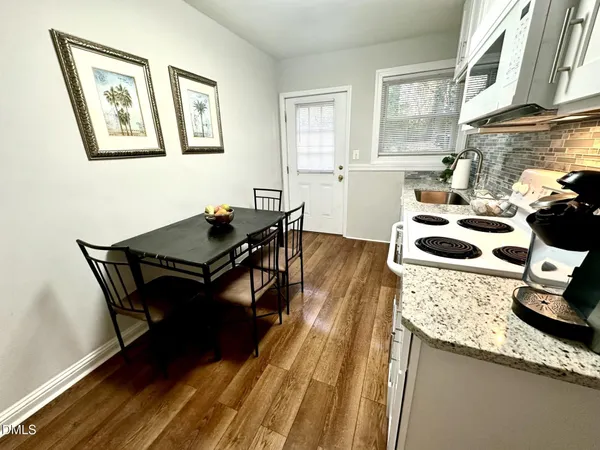 a kitchen with a table and chairs in it
