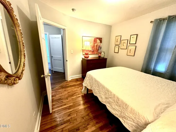 a bedroom with a bed and a mirror