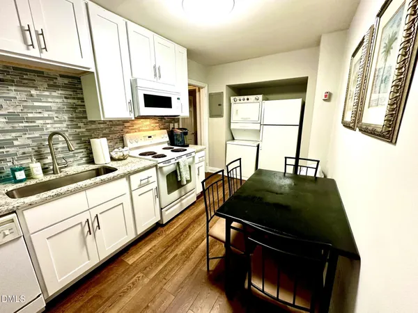 a kitchen with stainless steel appliances a stove a sink and a microwave