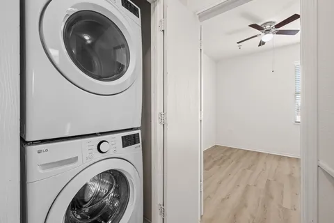 a view of a hallway with washer and dryer