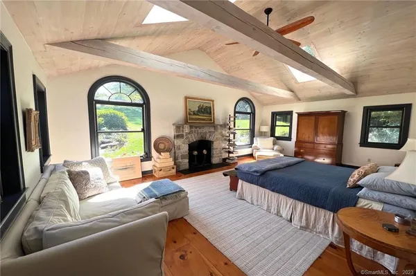 a living room with furniture fireplace and a large window